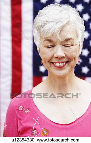 Stock Image - Close-up of a mature smiling with her eyes closed. Fotosearch