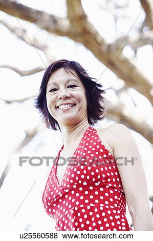 Portrait of a mature woman smiling View Large Photo Image Stock Photo - Portrait of a mature woman smiling. Fotosearch
