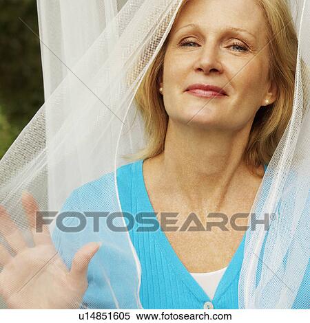 Stock Photography - Portrait of a mature woman smiling. Fotosearch