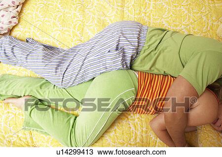 High angle view of a man and a woman lying in bed View Large Photo Image Stock Image - High angle view of a man and a woman lying in bed. Fotosearch