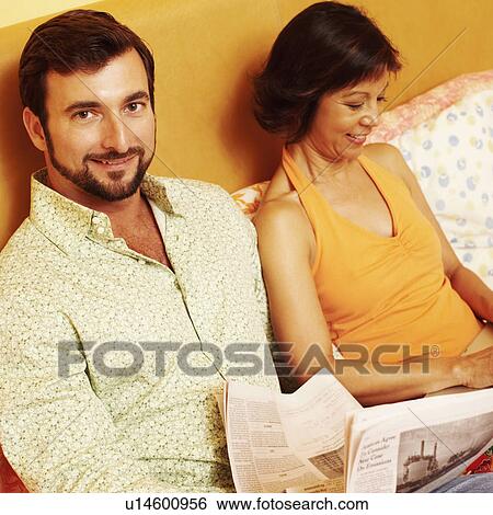 Stock Photograph - Portrait of a mature man smiling with a mature woman sitting beside him. Fotosearch