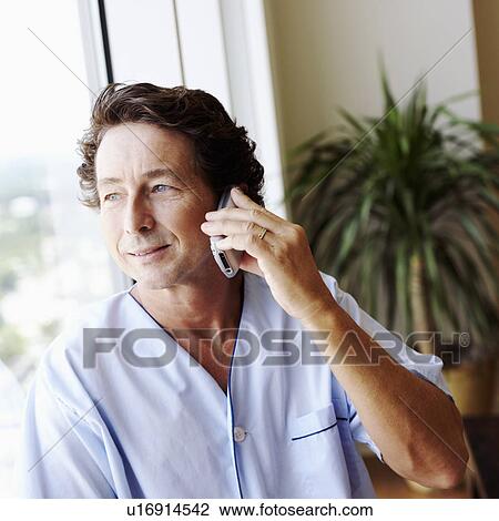 Close-up of a mature man talking on a mobile phone View Large Photo Image Stock Image - Close-up of a mature man talking on a mobile phone. Fotosearch