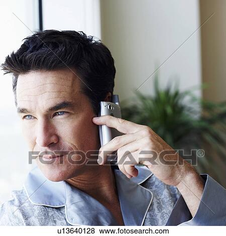 Stock Photo - Close-up of a mature man talking on a mobile phone. Fotosearch