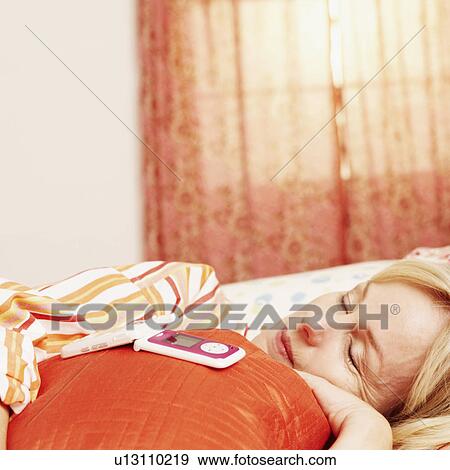 Close-up of a mature woman sleeping on the bed with a flip phone on the pillow View Large Photo Image Stock Photo - Close-up of a mature woman sleeping on the bed with a flip phone on the pillow. Fotosearch