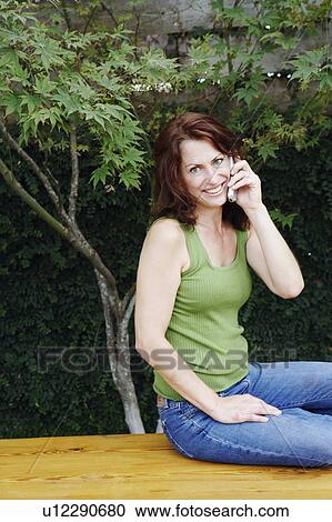 Portrait of a mature woman using a mobile phone View Large Photo Image Stock Image - Portrait of a mature woman using a mobile phone. Fotosearch