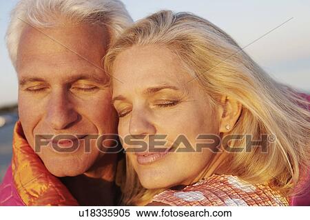 Stock Photography - Close-up of a mature couple smirking. Fotosearch