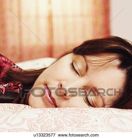 Stock Photo - Close-up of a mature woman sleeping on the bed. Fotosearch