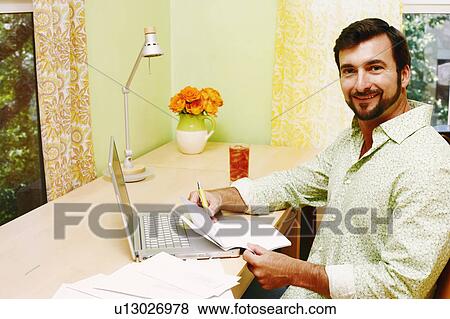 Stock Photo - Portrait of a mature man smiling and holding a document. Fotosearch