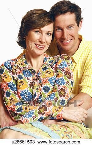 Portrait of a mid adult man embracing a mid adult woman and smiling View Large Photo Image Stock Image - Portrait of a mid adult man embracing a mid adult woman and smiling. Fotosearch