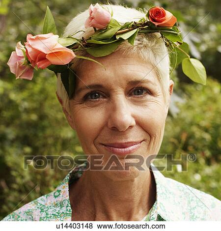 Portrait of a senior woman wearing a flower crown View Large Photo Image Stock Photo - Portrait of a senior woman wearing a flower crown. Fotosearch
