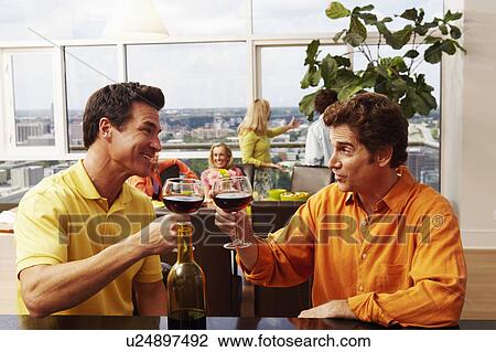 Close-up of two mature men toasting a drink View Large Photo Image Stock Image - Close-up of two mature men toasting a drink. Fotosearch