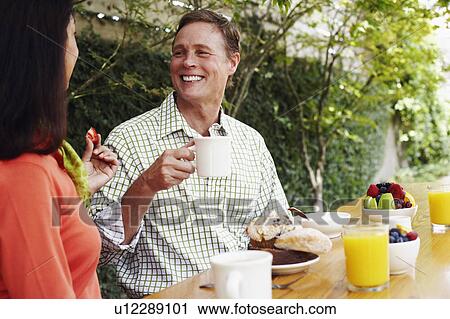 Mature couple having breakfast View Large Photo Image Stock Image - Mature couple having breakfast. Fotosearch