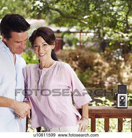 Stock Photo - Mature couple leaning against a railing. Fotosearch