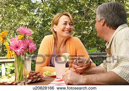Stock Photograph - Mature couple looking at each other and smiling. Fotosearch
