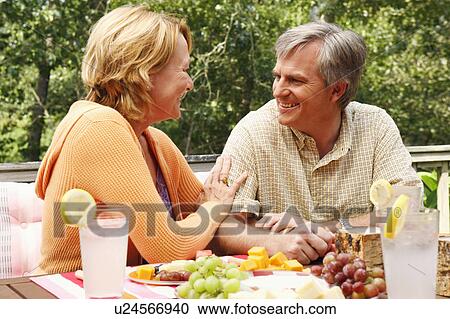 Mature couple looking at each other at the table View Large Photo Image Stock Image - Mature couple looking at each other at the table. Fotosearch