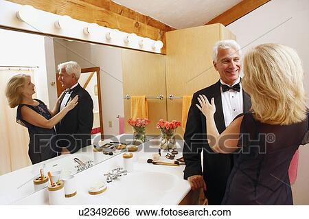 Stock Photograph - Mature couple looking at each other in the bathroom. Fotosearch
