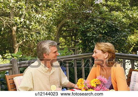 Stock Image - Mature couple smiling and looking at each other. Fotosearch