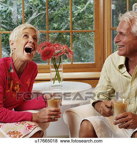 mature man and a senior woman sitting on chairs and holding mugs of coffee View Large Photo Image Stock Photo - mature man and a senior woman sitting on chairs and holding mugs of coffee. Fotosearch