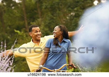 Mid adult woman with a mature man cycling View Large Photo Image Stock Photo - Mid adult woman with a mature man cycling. Fotosearch
