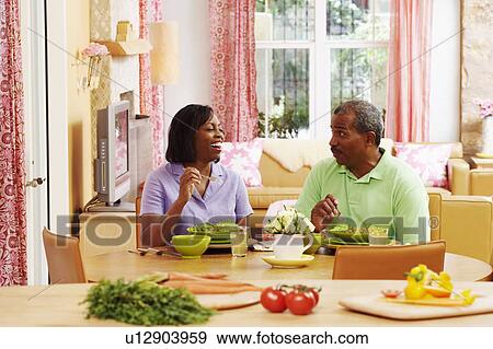Mature couple eating salad and talking View Large Photo Image Stock Photo - Mature couple eating salad and talking. Fotosearch
