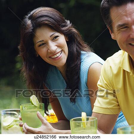 Stock Photograph - Mature couple holding glasses of lemonade. Fotosearch