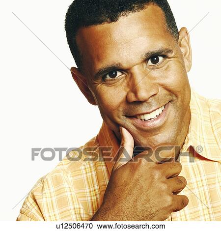 Portrait of a mature man smiling with his hand on his chin View Large Photo Image Stock Image - Portrait of a mature man smiling with his hand on his chin. Fotosearch
