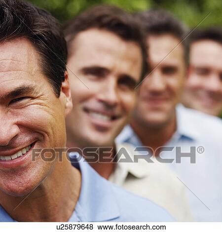Portrait of a mature man smiling with his friends in the background View Large Photo Image Stock Photo - Portrait of a mature man smiling with his friends in the background. Fotosearch