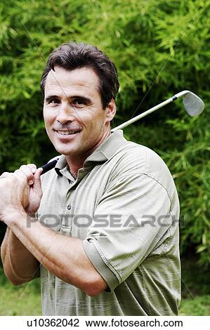 Close-up of a mature man holding a golf club View Large Photo Image Stock Image - Close-up of a mature man holding a golf club. Fotosearch