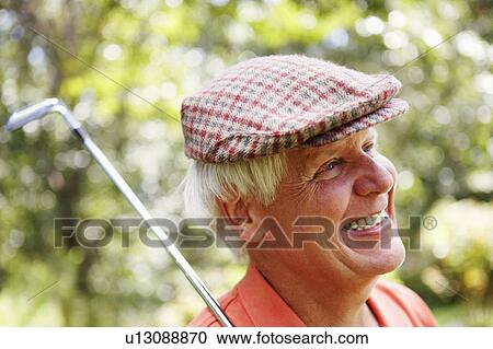 Close-up of a mature man with a golf club and smiling View Large Photo Image Stock Image - Close-up of a mature man with a golf club and smiling. Fotosearch
