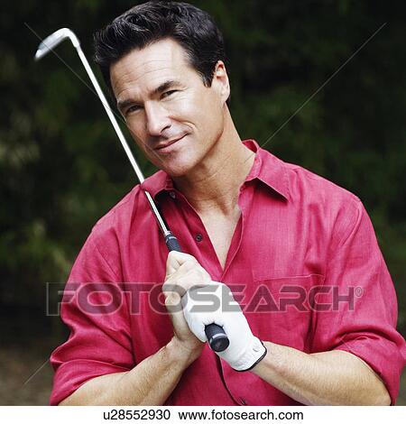 Portrait of a mature man holding a golf club and smiling View Large Photo Image Stock Image - Portrait of a mature man holding a golf club and smiling. Fotosearch