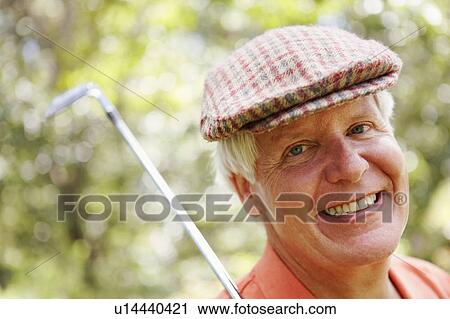 Portrait of a mature man with a golf club View Large Photo Image Stock Image - Portrait of a mature man with a golf club. Fotosearch