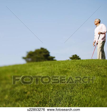 Side profile of a mature man holding a golf club View Large Photo Image Stock Photograph - Side profile of a mature man holding a golf club. Fotosearch
