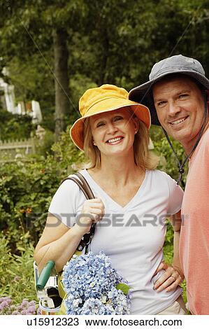 Portrait of a mature couple standing together and smiling View Large Photo Image Stock Image - Portrait of a mature couple standing together and smiling. Fotosearch