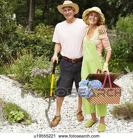 Portrait of a mature man and a senior woman standing in a garden View Large Photo Image Stock Image - Portrait of a mature man and a senior woman standing in a garden. Fotosearch
