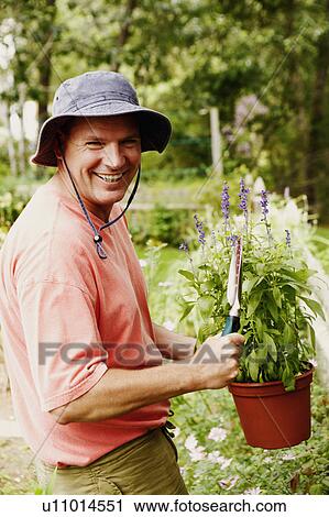 Stock Image - Portrait of a mature man gardening. Fotosearch