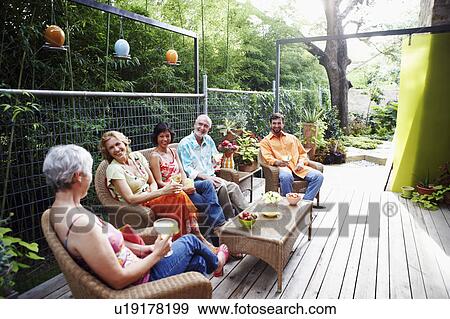 Five people sitting together and smiling View Large Photo Image Stock Photo - Five people sitting together and smiling. Fotosearch