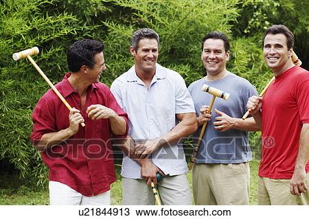 Mid adult man with three mature men holding croquet mallets and balls View Large Photo Image Stock Image - Mid adult man with three mature men holding croquet mallets and balls. Fotosearch