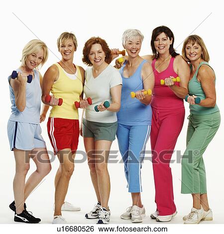 Stock Photograph - Portrait of a group of mature women holding dumbbells and smiling. Fotosearch