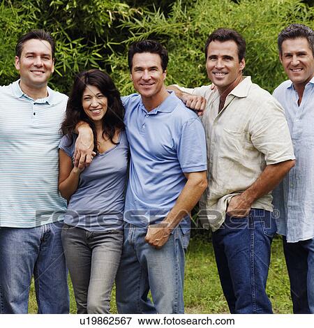 Stock Photo - Portrait of a group of people standing together and posing. Fotosearch