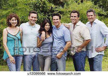 Stock Photograph - Portrait of a group of people standing together and posing. Fotosearch