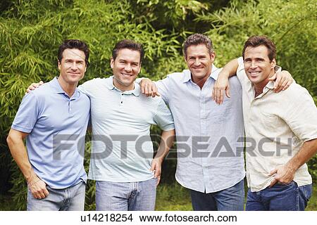 Portrait of a mid adult man with three mature men posing and smiling View Large Photo Image Picture - Portrait of a mid adult man with three mature men posing and smiling. Fotosearch