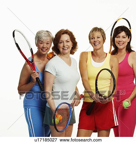 Portrait of four mature women holding tennis rackets and tennis balls View Large Photo Image Stock Photo - Portrait of four mature women holding tennis rackets and tennis balls. Fotosearch