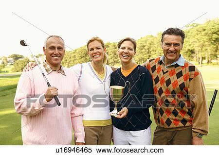Portrait of four people holding a trophy View Large Photo Image Stock Photography - Portrait of four people holding a trophy. Fotosearch