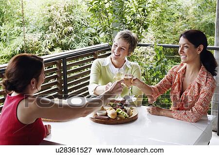 Three mature women toasting with champagne flutes View Large Photo Image Stock Photo - Three mature women toasting with champagne flutes. Fotosearch