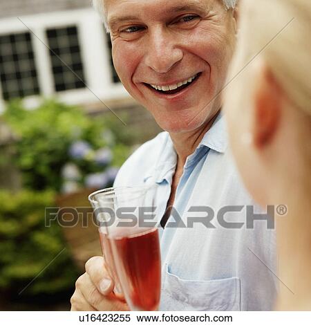 Mature couple holding champagne flutes View Large Photo Image Stock Photography - Mature couple holding champagne flutes. Fotosearch