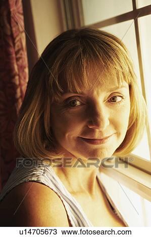 Stock Image - Portrait of a mature woman grinning. Fotosearch