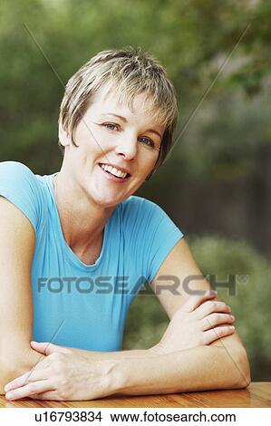 Portrait of a mature woman smiling View Large Photo Image Picture - Portrait of a mature woman smiling. Fotosearch