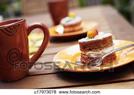Close-up of a pastry in a plate with a mug on a table View Large Photo Image Stock Photo - Close-up of a pastry in a plate with a mug on a table. Fotosearch