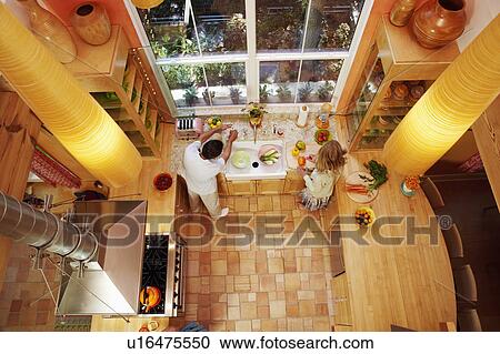 High angle view of a mature couple cutting vegetables in the kitchen View Large Photo Image Stock Image - High angle view of a mature couple cutting vegetables in the kitchen. Fotosearch