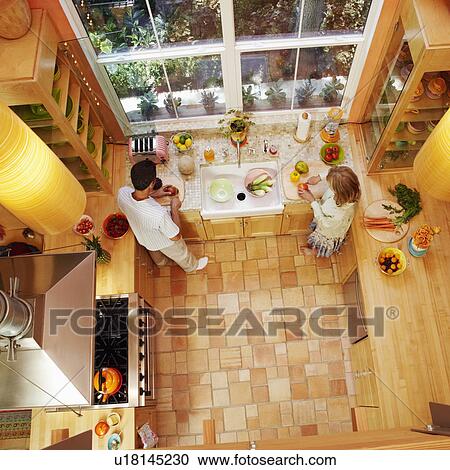 High angle view of a mature couple cutting vegetables in the kitchen View Large Photo Image Stock Image - High angle view of a mature couple cutting vegetables in the kitchen. Fotosearch